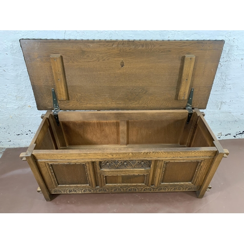 186 - An Old Charm carved oak and green vinyl upholstered blanket box - approx. 50cm high x 123cm wide x 4... 