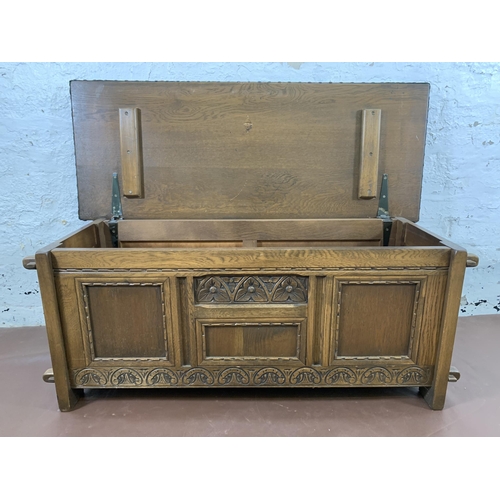 186 - An Old Charm carved oak and green vinyl upholstered blanket box - approx. 50cm high x 123cm wide x 4... 