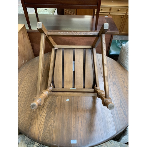 192 - An Ercol Old Colonial elm and beech drop leaf dining table and four Yorkshire dining chairs - table ... 