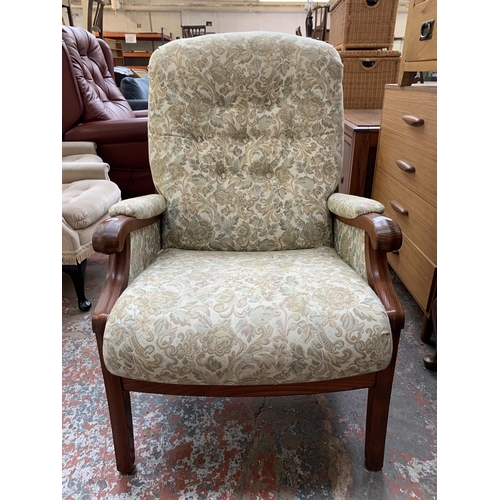 194 - A late 20th century elm and floral fabric upholstered armchair