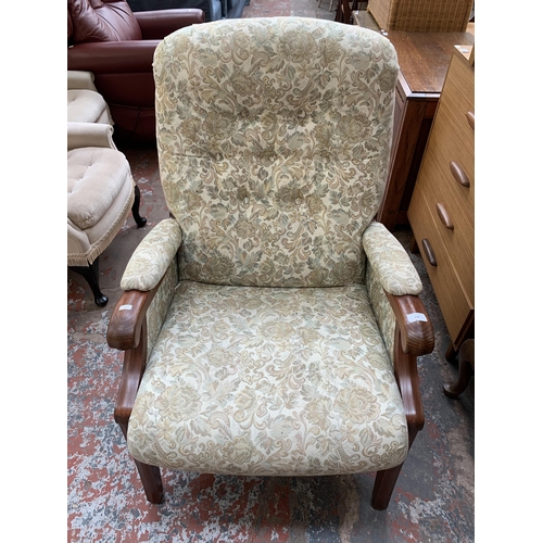 194 - A late 20th century elm and floral fabric upholstered armchair