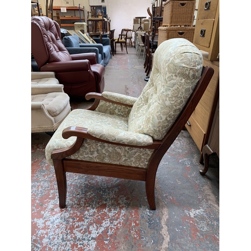 194 - A late 20th century elm and floral fabric upholstered armchair