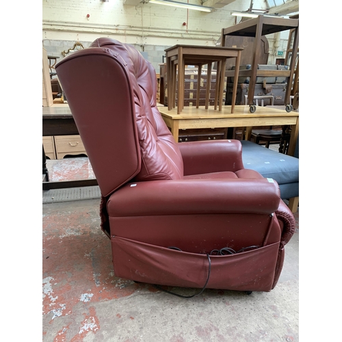 196 - A modern burgundy leather electric rise and recline armchair with remote control and power supply