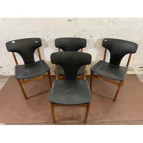 20 - Four mid 20th century teak and black vinyl upholstered dining chairs