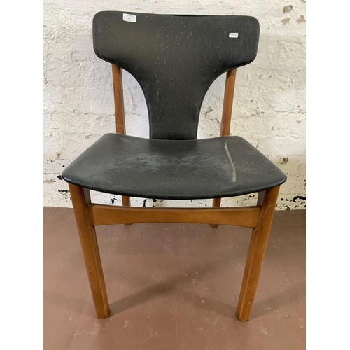 20 - Four mid 20th century teak and black vinyl upholstered dining chairs