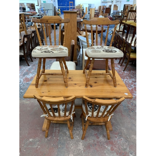 202 - A pine rectangular dining table and four chairs