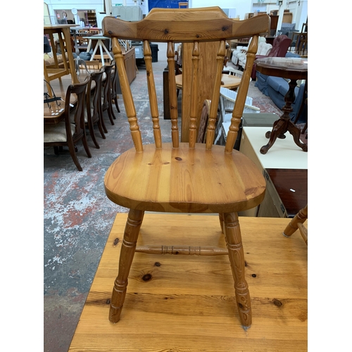 202 - A pine rectangular dining table and four chairs