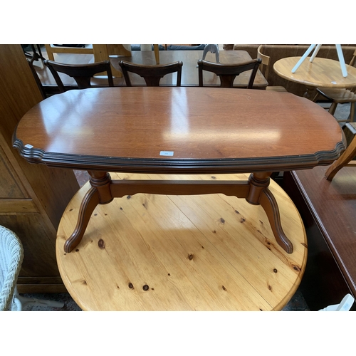 208 - A 19th century style mahogany serpentine twin pedestal coffee table