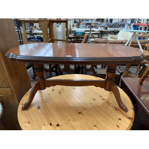 208 - A 19th century style mahogany serpentine twin pedestal coffee table