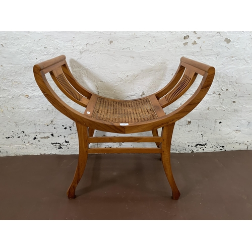 210 - An Indian hardwood and rattan Kartini single seat bench - approx. 69cm high x 69cm wide x 38cm deep