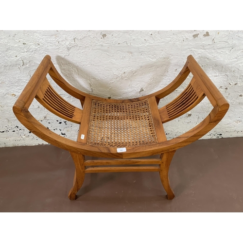 210 - An Indian hardwood and rattan Kartini single seat bench - approx. 69cm high x 69cm wide x 38cm deep