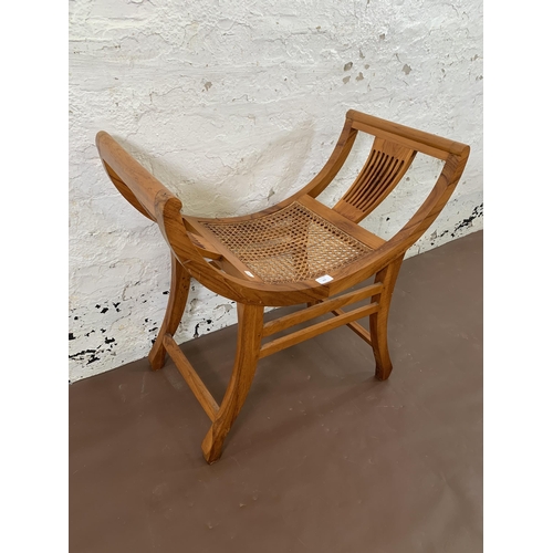 210 - An Indian hardwood and rattan Kartini single seat bench - approx. 69cm high x 69cm wide x 38cm deep