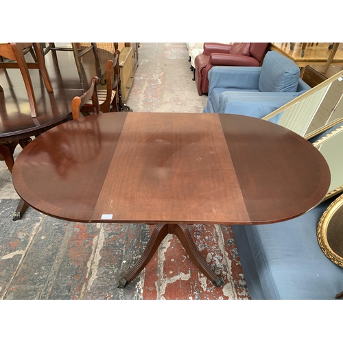 211 - A Georgian style mahogany drop leaf dining table