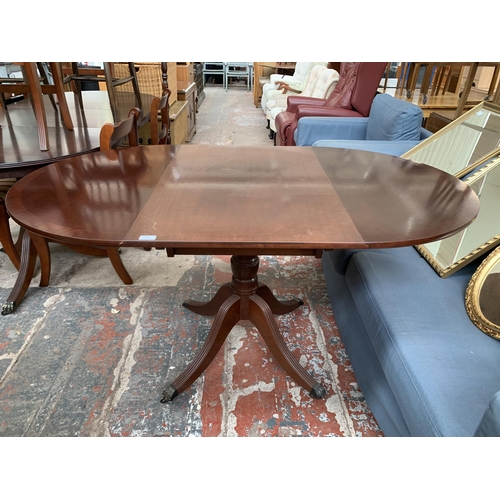 211 - A Georgian style mahogany drop leaf dining table