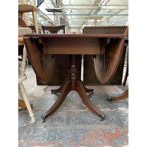 211 - A Georgian style mahogany drop leaf dining table