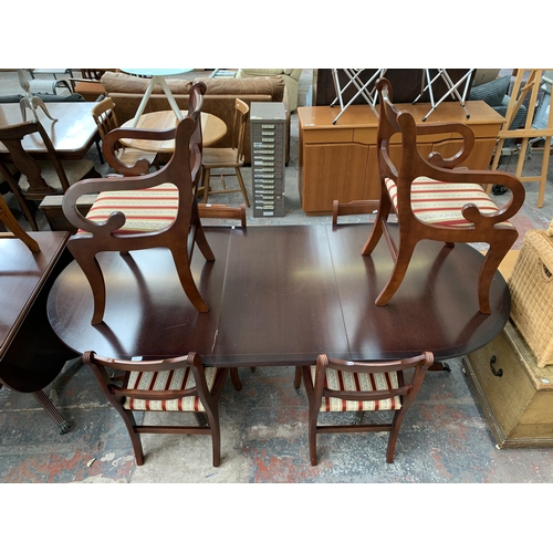 212 - A Georgian style mahogany twin pedestal extending D end dining table and six chairs