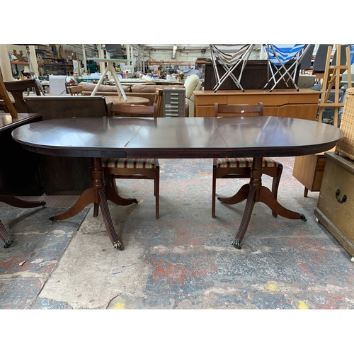 212 - A Georgian style mahogany twin pedestal extending D end dining table and six chairs