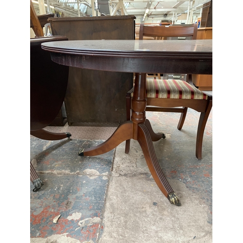 212 - A Georgian style mahogany twin pedestal extending D end dining table and six chairs