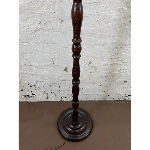 214 - A beech standard lamp with circular base - approx. 140cm high