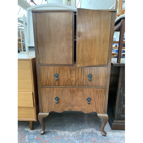 220 - A Raleigh Furniture walnut cabinet with two upper cupboard doors and two lower drawers on cabriole s... 