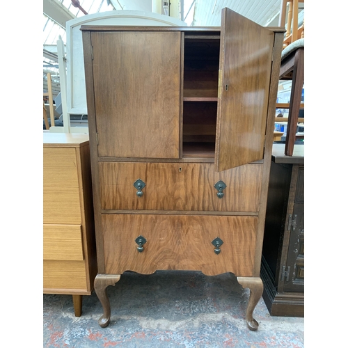 220 - A Raleigh Furniture walnut cabinet with two upper cupboard doors and two lower drawers on cabriole s... 