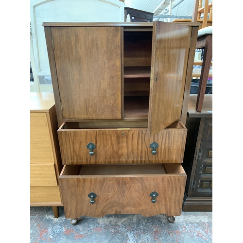 220 - A Raleigh Furniture walnut cabinet with two upper cupboard doors and two lower drawers on cabriole s... 