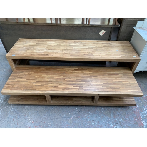 225 - A modern solid oak TV stand with removable storage compartment on castors - approx. 54cm high x 180c... 