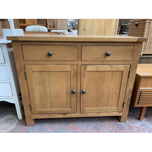 228 - A modern oak sideboard - approx. 81cm high x 100cm wide x 40cm deep