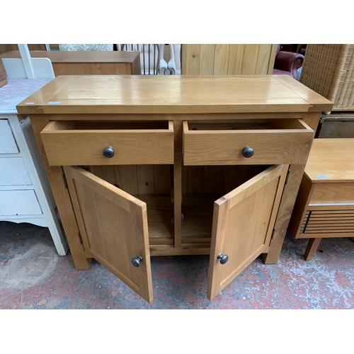 228 - A modern oak sideboard - approx. 81cm high x 100cm wide x 40cm deep