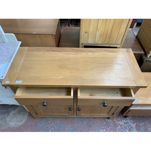 228 - A modern oak sideboard - approx. 81cm high x 100cm wide x 40cm deep