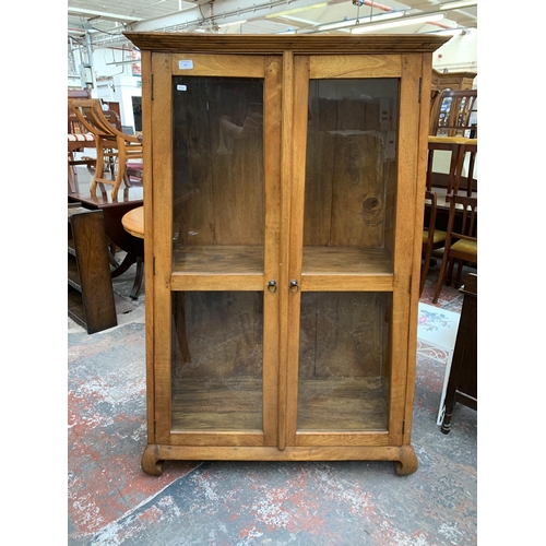 231 - A mango wood display cabinet - approx. 159cm high x 109cm wide x 42cm deep