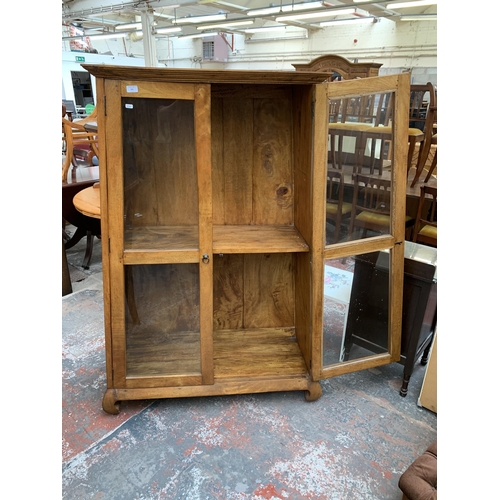 231 - A mango wood display cabinet - approx. 159cm high x 109cm wide x 42cm deep