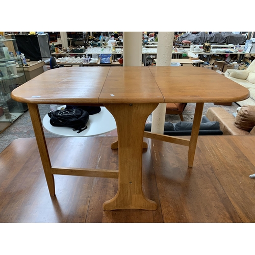 235 - A modern beech drop leaf gateleg dining table - approx. 74cm high x 75cm wide x 120cm long