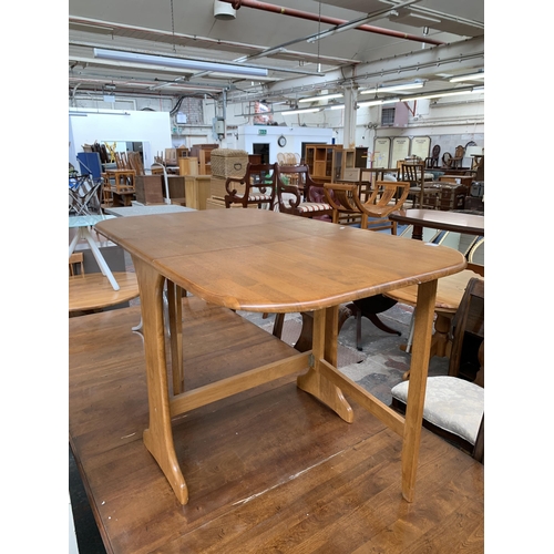 235 - A modern beech drop leaf gateleg dining table - approx. 74cm high x 75cm wide x 120cm long