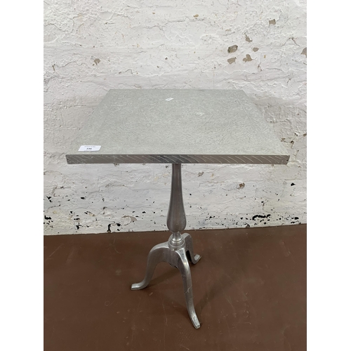 236 - An Indian embossed metal square top tripod side table - approx. 69cm high x 41cm wide