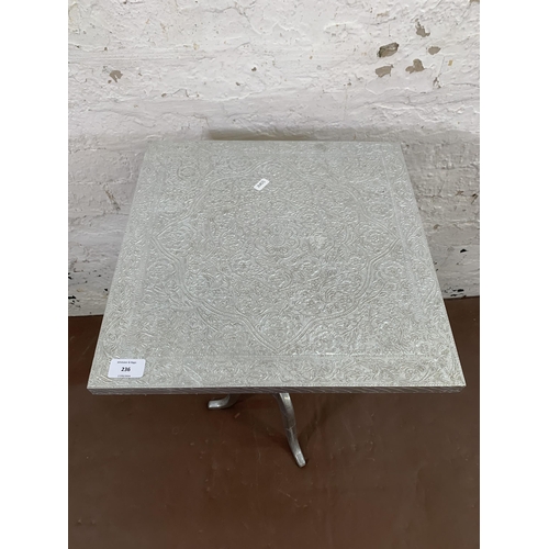 236 - An Indian embossed metal square top tripod side table - approx. 69cm high x 41cm wide