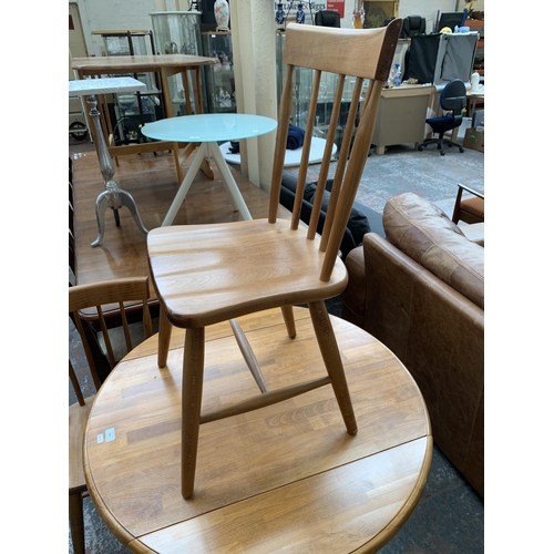 239 - A modern beech circular drop leaf dining table and two chairs - approx. 75cm high x 91cm diameter