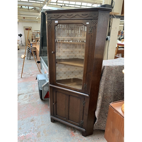 244 - A carved oak freestanding corner cabinet