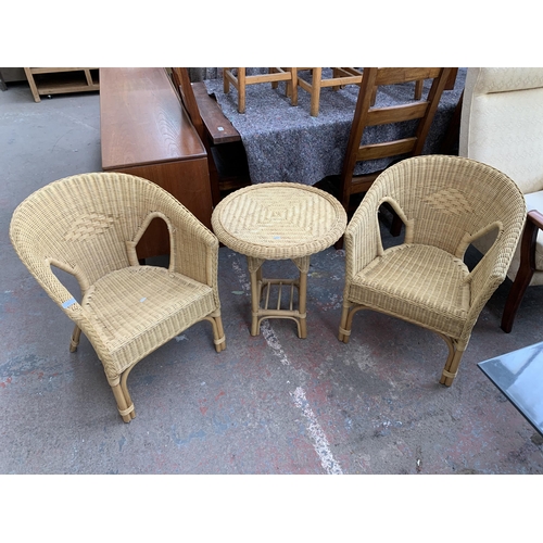 250 - Three pieces of wicker and cane furniture, two armchairs and one circular side table