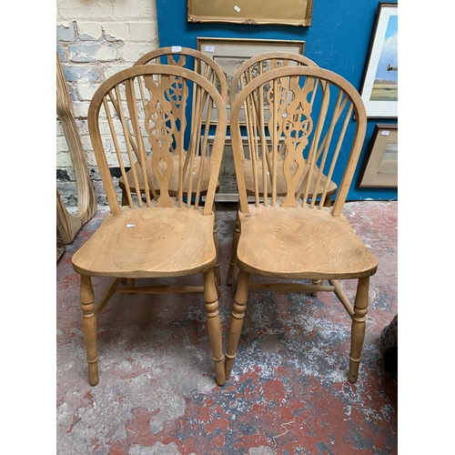 27 - Four elm and beech wheelback dining chairs