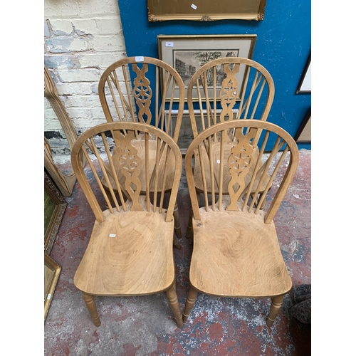 27 - Four elm and beech wheelback dining chairs