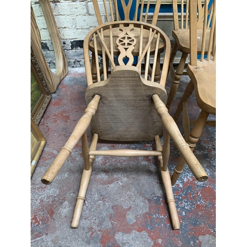 27 - Four elm and beech wheelback dining chairs