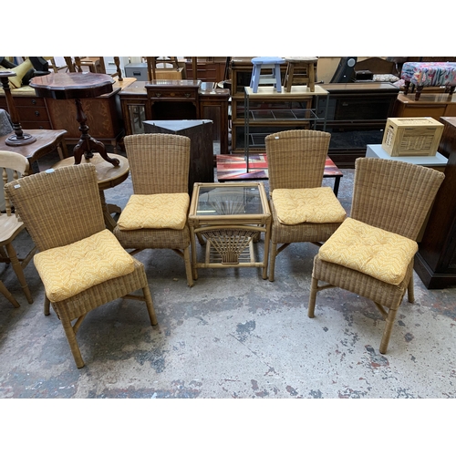 29 - Five pieces of wicker and cane furniture, four dining chairs and one glass top square side table