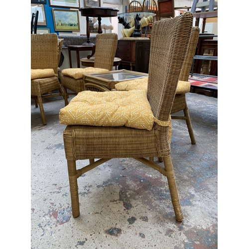 29 - Five pieces of wicker and cane furniture, four dining chairs and one glass top square side table