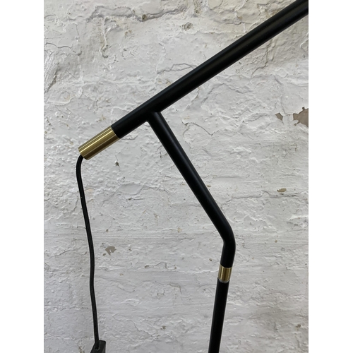 33 - A modern black metal and brass LED floor lamp - approx. 130cm high