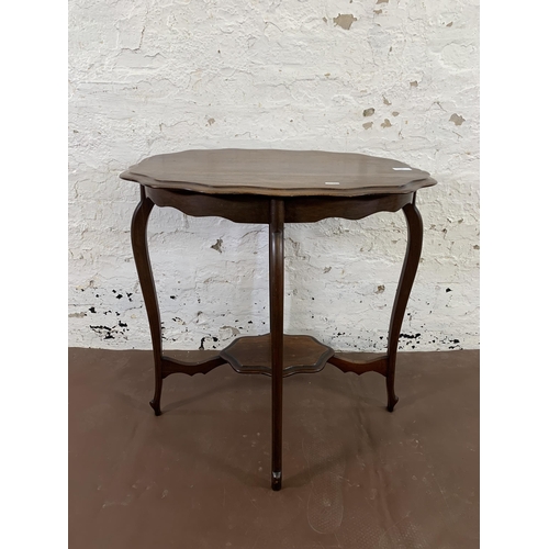 36 - A late 19th/early 20th century mahogany serpentine two tier side table