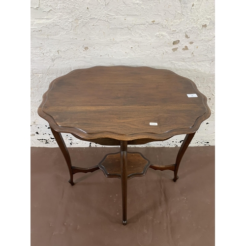 36 - A late 19th/early 20th century mahogany serpentine two tier side table