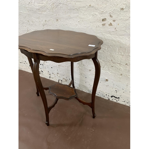 36 - A late 19th/early 20th century mahogany serpentine two tier side table