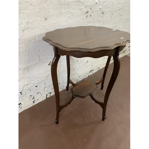 36 - A late 19th/early 20th century mahogany serpentine two tier side table