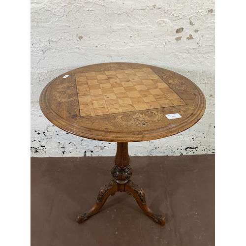 37 - A Victorian inlaid walnut circular tripod games table - approx. 68cm high x 53cm diameter